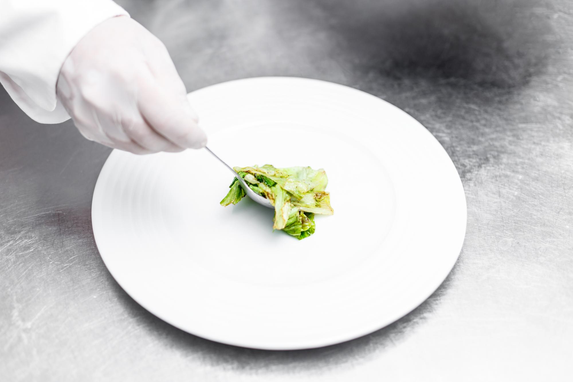 Chef plating a simple meal